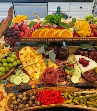Charcuterie board full of colorful appetizing food grazing table